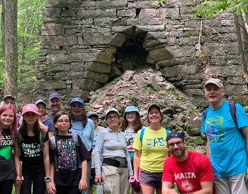 Tour group standing in front of historic Mount Hope Furnace