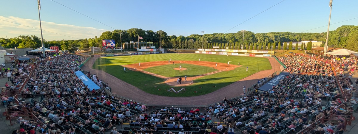 people watching a baseball game at a stadium