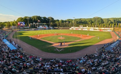 people watching a baseball game at a stadium
