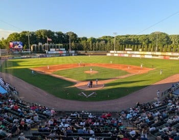 people watching a baseball game at a stadium