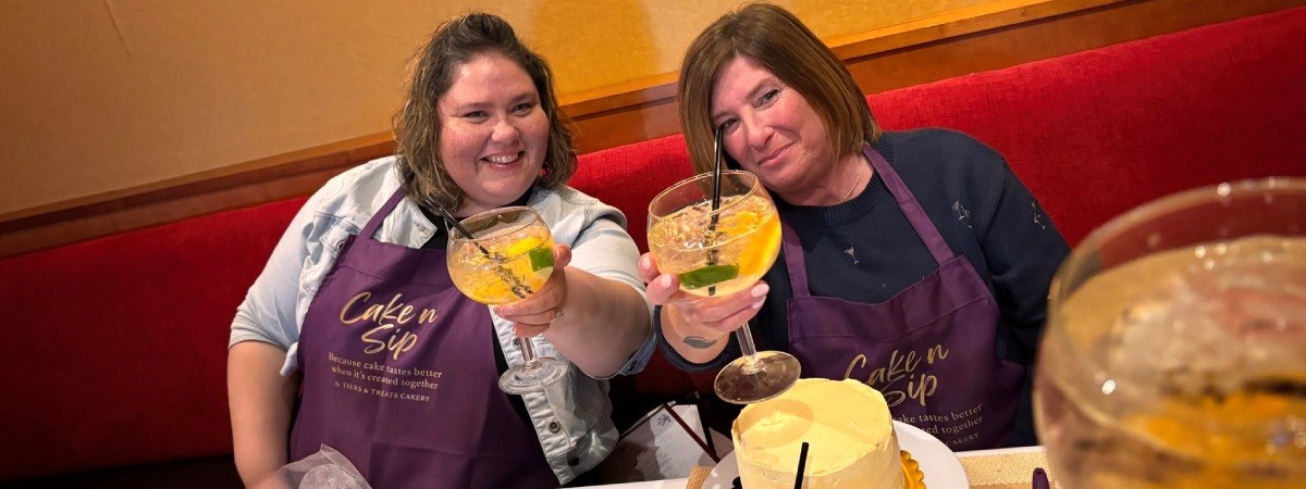 two women at a cake n sip event