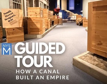 Guided Tour How a Canal Built an Empire text with wooden shipping boxes.