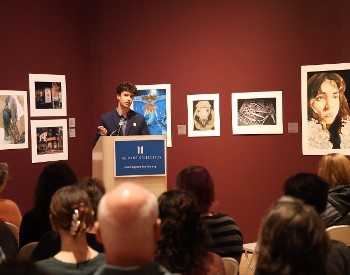 Student reading artist statement at The Hyde Collection.