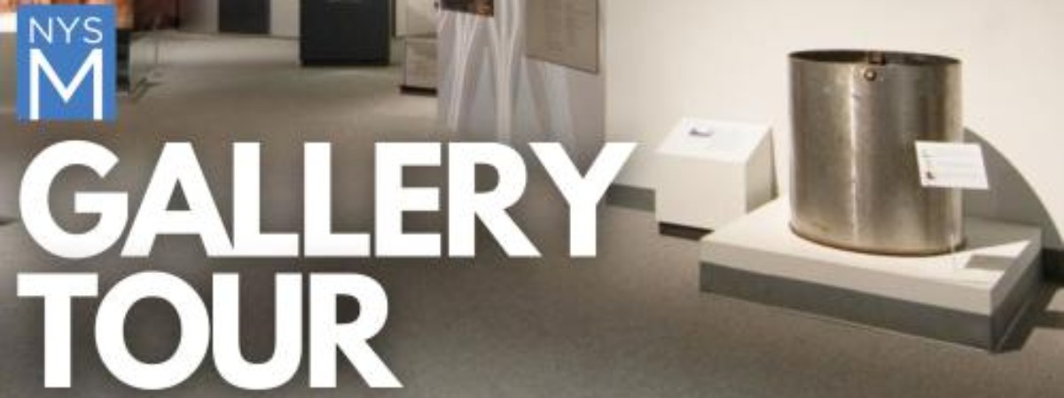 Text: Gallery Tour with World Trade Center artifacts in background
