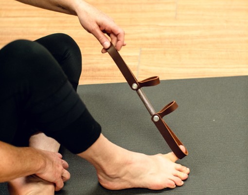 A woman using a Rescue Loop for toe exercises