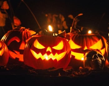 Glowing carved jack-o-lanterns displayed at Night of the Jack-o-Lanterns at Artisanal Brew Works in Saratoga Springs.