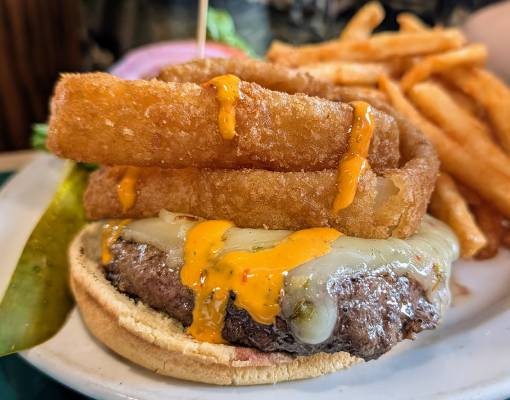 burger with onion rings on top