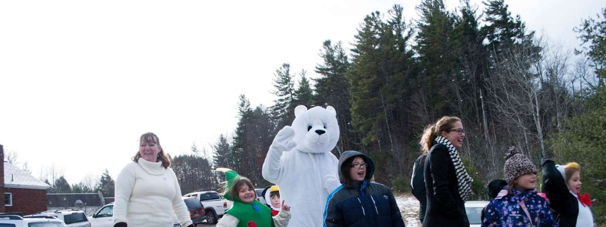 people with polar bear on float in parade