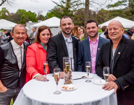 people standing around a table with champagne