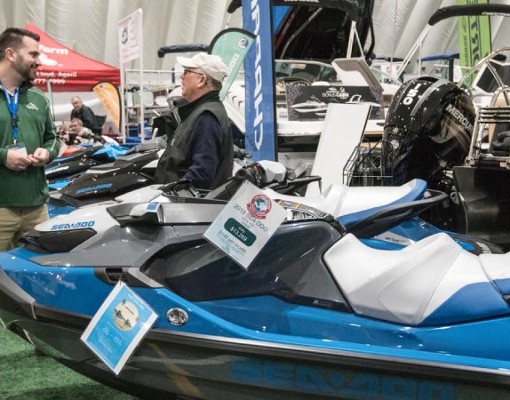 people talking with vendor at jet skis