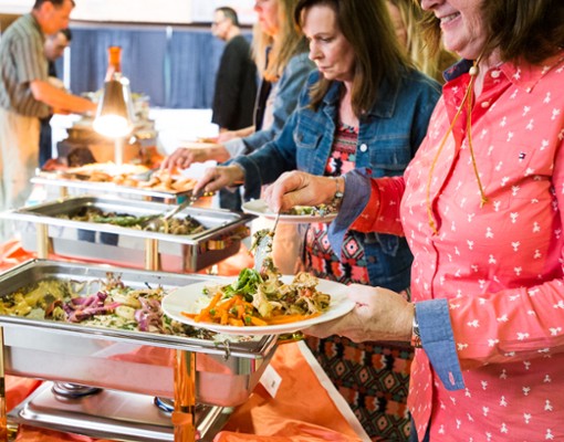 guests loading up their plates with buffet food