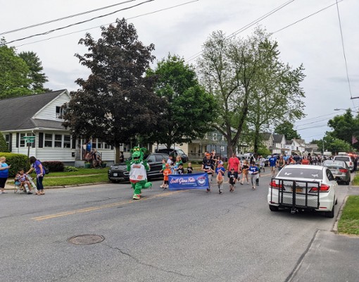 sports team with mascot in parade