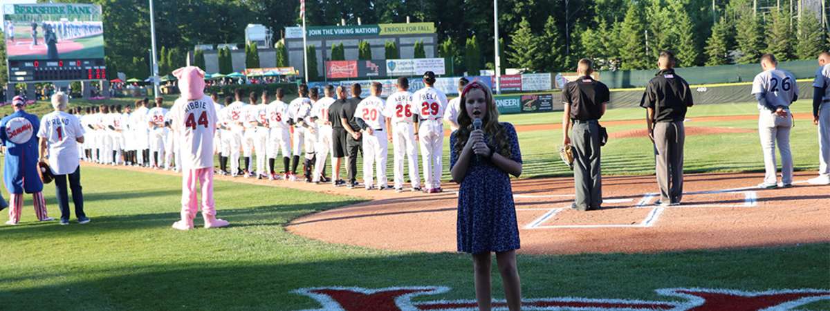 girl singing the national anthem at a valleycats game