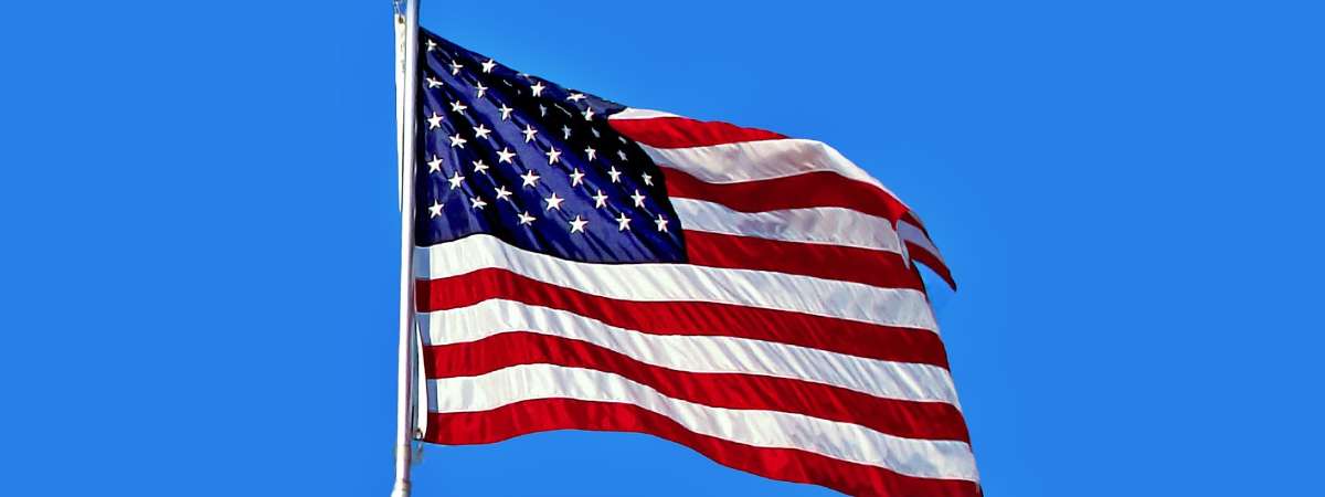 an American flag against blue sky
