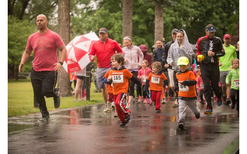kids and parents running in the rain