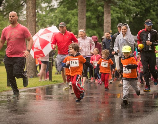 kids and parents running in the rain