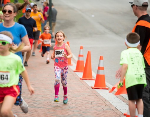 kids running in race by traffic cones