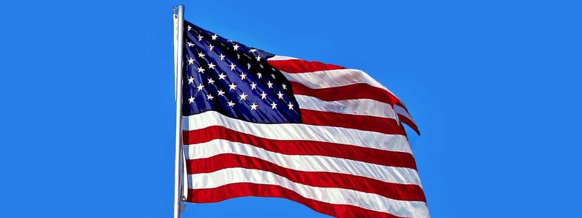 an American flag against blue sky