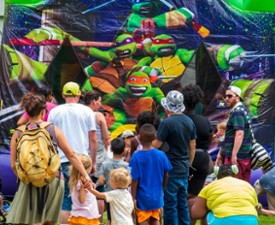 MVP Kids Day crowd at a ninja turtles bounce house