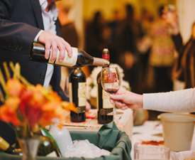 man pouring wine at a tasting