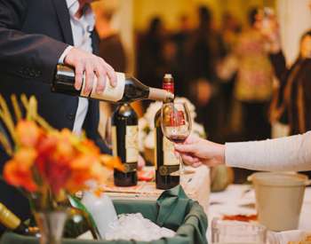 man pouring wine at a tasting