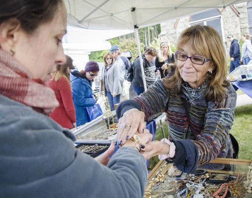 woman helping woman with bracelet