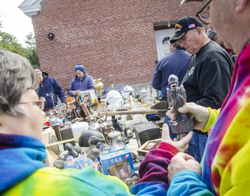 vintage collectibles on tables at garage sale