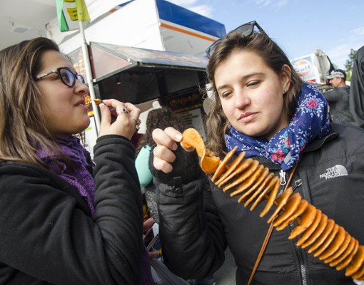 woman holding stick of snacks