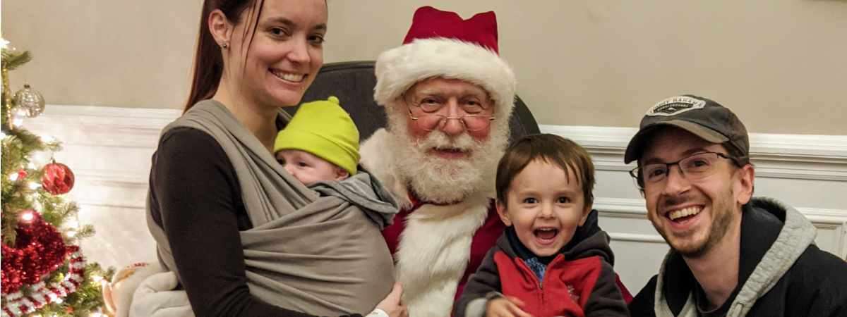 family of four poses with santa
