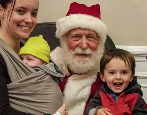 family of four poses with santa