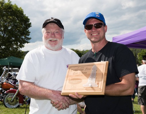 men shaking hands with plaque
