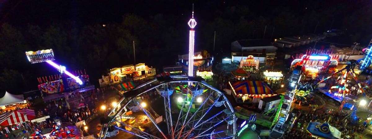 aerial view of a colorful fair midway at night