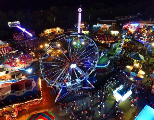 aerial view of a colorful fair midway at night