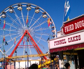 ferris wheel with food stand next to it