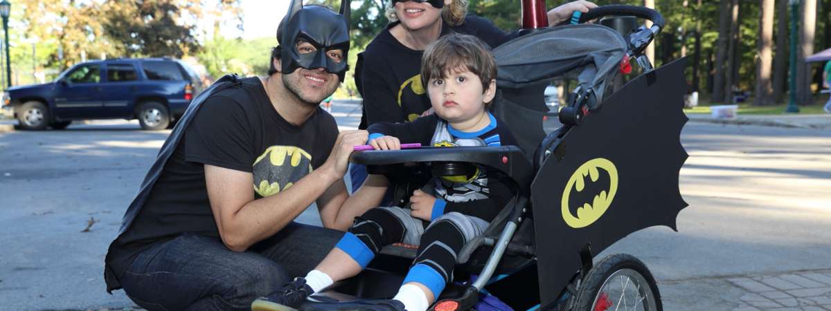 a couple with kid in batman stroller