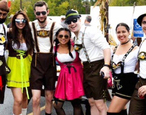 group poses for picture dressed in oktoberfest clothing