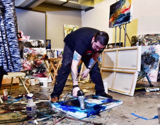 artist working with a hairdryer