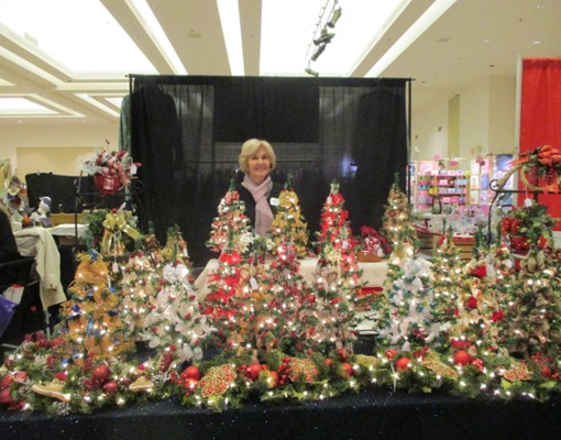 woman behind small christmas trees