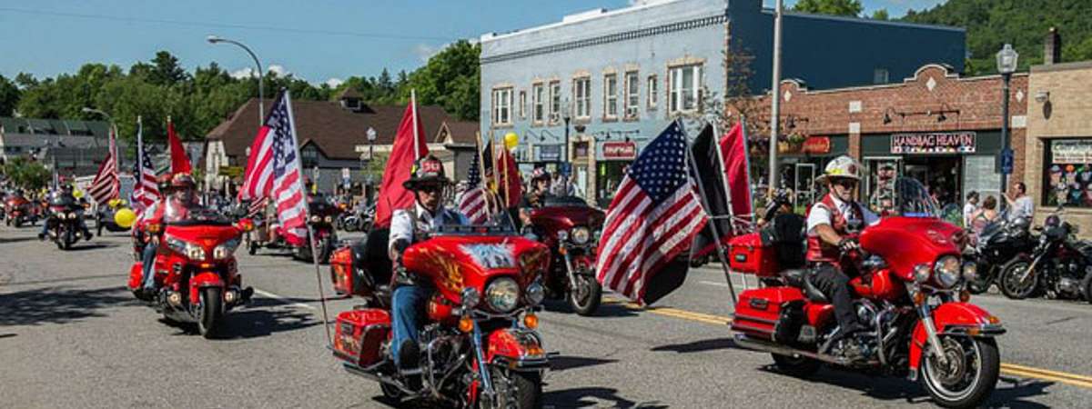 parade of motorcycles with american flags