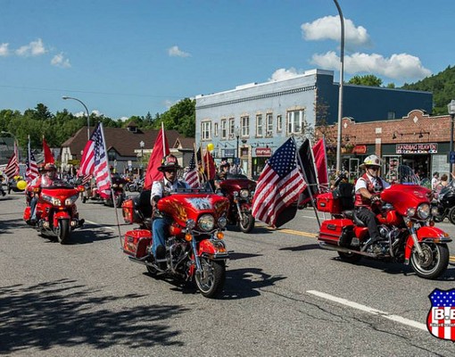 parade of motorcycles with american flags