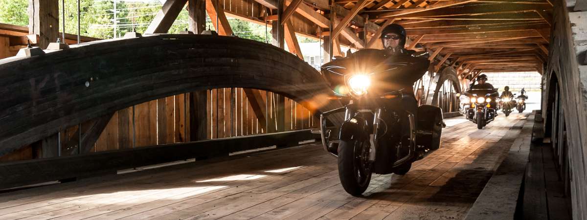 motorcycle rolling through a covered bridge