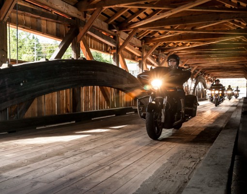 motorcycle rolling through a covered bridge