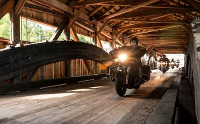 motorcycles on covered bridge