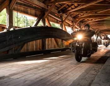 motorcycles on covered bridge