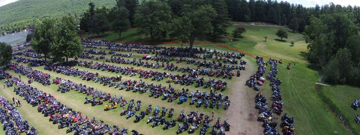 large field with parked motorcycles in it