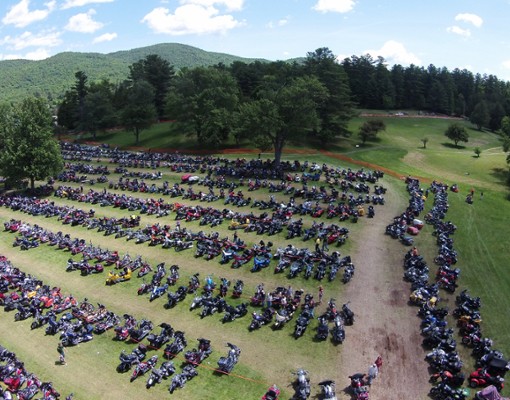 large field with parked motorcycles in it