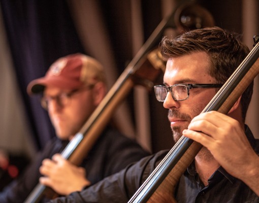 two men playing upright bass