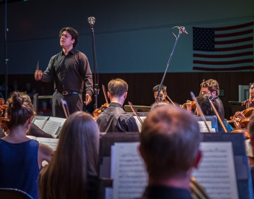 conductor leading orchestra