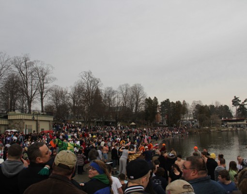 crowd of people near a lake shoreline