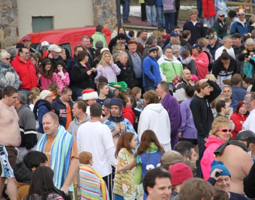 a large group of people preparing for a polar plunge